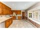Kitchen featuring wooden cabinets, tile backsplash, and a window seat with storage at 3541 Castlehill Ct, Tucker, GA 30084