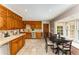 Traditional kitchen with wooden cabinetry, stainless steel appliances, and a breakfast nook with bay window at 3541 Castlehill Ct, Tucker, GA 30084