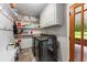 Laundry room with hook rack, floating shelves, tile floor, and side-by-side washer and dryer at 3541 Castlehill Ct, Tucker, GA 30084