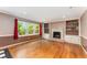 Spacious living room with hardwood floors, natural light, and fireplace with built-in shelving at 3541 Castlehill Ct, Tucker, GA 30084