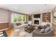 Bright living room with a fireplace, built-in shelving, and large window overlooking the greenery at 3541 Castlehill Ct, Tucker, GA 30084