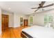 This main bedroom boasts hardwood floors, ceiling fan, access to bathroom, and french door access to the backyard at 3541 Castlehill Ct, Tucker, GA 30084