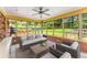 Enclosed sunroom with brick accents and views of the fenced-in backyard with mature trees at 3541 Castlehill Ct, Tucker, GA 30084