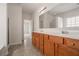 Bathroom featuring double sinks, wood cabinets, and large mirror at 7761 Parkside Dr, Lithia Springs, GA 30122