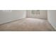 Bedroom featuring neutral carpet, white walls and a large window offering natural light at 7761 Parkside Dr, Lithia Springs, GA 30122