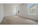 Spacious, carpeted bedroom with natural light from large windows, showcasing its potential at 7761 Parkside Dr, Lithia Springs, GA 30122