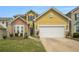 Well-maintained home with a two-car garage, stone accents, and landscaped front yard at 7761 Parkside Dr, Lithia Springs, GA 30122