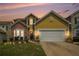 Charming home features a two-car garage, manicured lawn, and beautiful landscaping at 7761 Parkside Dr, Lithia Springs, GA 30122