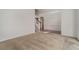 Bright foyer with hardwood floors, a staircase, and an archway leading to the living room at 7761 Parkside Dr, Lithia Springs, GA 30122