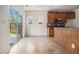 Eat in kitchen with wood cabinets, stainless appliances, tile floor, and sliding doors leading to the backyard at 7761 Parkside Dr, Lithia Springs, GA 30122