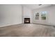 Carpeted living room with a fireplace, large windows and a high ceiling at 7761 Parkside Dr, Lithia Springs, GA 30122