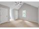 Bedroom with neutral carpet, vaulted ceiling, ceiling fan, and white trim offering a cozy space at 1940 Country Pl, Cumming, GA 30040