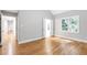 Spacious bedroom with hardwood floors and ample natural light from large windows, complemented by neutral paint at 1940 Country Pl, Cumming, GA 30040