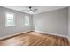 Bright bedroom with hardwood floors, dual windows, ceiling fan and neutral paint for a light, airy feel at 1940 Country Pl, Cumming, GA 30040