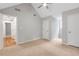 Spacious bedroom with neutral carpet, multiple doors, and ceiling fan offering flexibility at 1940 Country Pl, Cumming, GA 30040