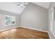 Bright bedroom featuring hardwood floors, a vaulted ceiling, and large windows providing natural light at 1940 Country Pl, Cumming, GA 30040
