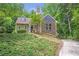 Charming home with a stone and siding exterior surrounded by lush greenery at 1940 Country Pl, Cumming, GA 30040
