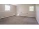 Spacious basement features plush carpet, two windows, and neutral colors at 4331 Wrexham Ct, Snellville, GA 30039