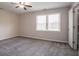 Cozy bedroom with soft gray walls and plush gray carpet, complemented by a ceiling fan at 4331 Wrexham Ct, Snellville, GA 30039
