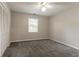 Bedroom featuring gray carpet, a window, and a closet with sliding doors at 4331 Wrexham Ct, Snellville, GA 30039