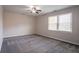 Bright bedroom with gray carpet, neutral walls, a ceiling fan, and a window for natural light at 4331 Wrexham Ct, Snellville, GA 30039