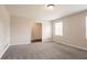 This cozy bedroom features soft gray walls and carpets, complemented by a window for natural light at 4331 Wrexham Ct, Snellville, GA 30039