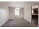Cozy dining room with gray carpet, neutral walls, a chandelier, and a view into the kitchen at 4331 Wrexham Ct, Snellville, GA 30039