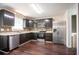 Modern kitchen with stainless steel appliances, dark cabinetry, and granite countertops at 4331 Wrexham Ct, Snellville, GA 30039