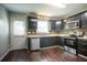 Well-equipped kitchen with stainless steel appliances, dark wood cabinets, and sleek countertops at 4331 Wrexham Ct, Snellville, GA 30039