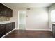 Bright kitchen featuring dark cabinetry, stainless appliances, and a view into the adjacent living area at 4331 Wrexham Ct, Snellville, GA 30039