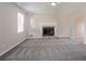 Cozy living room featuring a stone fireplace, neutral paint, and carpeted flooring at 4331 Wrexham Ct, Snellville, GA 30039
