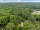 Aerial view of a tree-surrounded home with a driveway at 1736 Morris Landers Ne Dr, Atlanta, GA 30345
