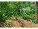 Stone and gravel walkway in a lush, wooded backyard at 1736 Morris Landers Ne Dr, Atlanta, GA 30345