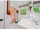 Bathroom featuring a pedestal sink, subway tile, and a window providing natural light at 1736 Morris Landers Ne Dr, Atlanta, GA 30345