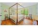 This bedroom features a four-poster bed, hardwood floors, and abundant natural light at 1736 Morris Landers Ne Dr, Atlanta, GA 30345