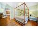 This bedroom features hardwood floors, a four-poster bed, and neutral wall colors at 1736 Morris Landers Ne Dr, Atlanta, GA 30345