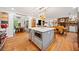 A spacious kitchen with hardwood floors, a central island with a marble countertop, and stainless steel appliances at 1736 Morris Landers Ne Dr, Atlanta, GA 30345