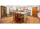 The kitchen features white cabinets, stainless steel appliances, a gray central island and beautiful hardwood floors at 1736 Morris Landers Ne Dr, Atlanta, GA 30345