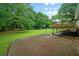 View of a concrete patio and wooden deck in a large grassy backyard at 2056 Merle Se Dr, Conyers, GA 30013