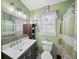 Charming bathroom with updated vanity, neutral wall color, and shower and tub with curtain at 2056 Merle Se Dr, Conyers, GA 30013