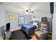 Comfortable bedroom with hardwood floors, ceiling fan, bed with nightstands, and sitting chair at 2056 Merle Se Dr, Conyers, GA 30013