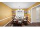 Formal dining room featuring wood floors, updated lighting, and natural light from the large window at 2056 Merle Se Dr, Conyers, GA 30013