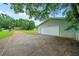 Exterior shot of large two car garage and long driveway leading to the main home at 2056 Merle Se Dr, Conyers, GA 30013