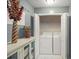 Functional laundry room with white cabinets, tile flooring, washer, and dryer at 2056 Merle Se Dr, Conyers, GA 30013