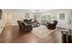Spacious living room with hardwood floors, plush seating, and ample natural light at 2056 Merle Se Dr, Conyers, GA 30013