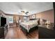 Spacious main bedroom with hardwood floors, ceiling fan, and a king-sized bed at 2056 Merle Se Dr, Conyers, GA 30013