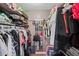 Walk-in closet featuring built-in shelving, clothing rods, and wood flooring at 2056 Merle Se Dr, Conyers, GA 30013