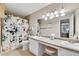 A bathroom featuring double sinks, granite countertop, and tiled shower/tub at 5145 Roswell Road # 3, Atlanta, GA 30342