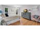 A Primary bedroom features a dresser, lamps, chair, windows and a hardwood floor at 5145 Roswell Road # 3, Atlanta, GA 30342