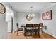 Cozy dining room features wood floors, a chandelier, and seating for four at 5145 Roswell Road # 3, Atlanta, GA 30342